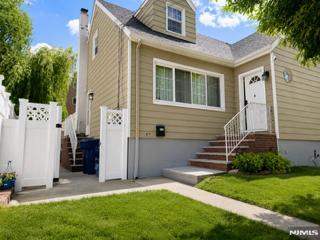 Renovated beautiful home with a great layout â€” looks can be deceiving, as this home is much larger than it appears! Featuring 5 bedrooms, with large family room walkout lower level, accessible from both the backyard and first floor. Large eat-in kitchen with granite countertops, stainless steel appliances, and a semi-island offering plenty of cabinet space. Sliding doors from the dining area lead to a large deck, and the kitchen also features a convenient side entrance. Hardwood floors throughout. Enjoy 3 full bathrooms, including a lower-level bath with a jacuzzi tub. The lower level also offers a laundry area and summer kitchen setup. Step outside to a large deck with a gas grill, overlooking a private fenced backyard complete with a pizza oven, shed, gazebo, and custom garden pavers with lighting â€” perfect for gatherings and entertaining. Spacious driveway accommodates several vehicles. Conveniently located near schools, parks, and public transportation. Nothing to do but unpack and move right in!