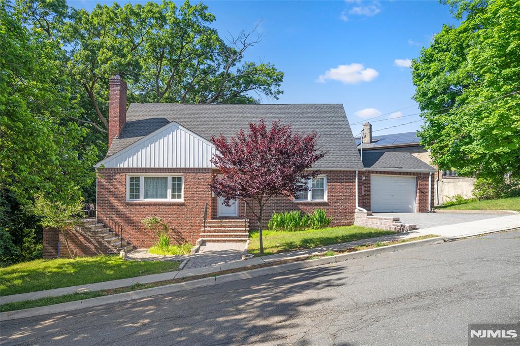 Welcome to this beautifully maintained and spacious Colonial/Cape Cod style home located on a desirable corner lot in the heart of Ridgefield. Featuring 4 bedrooms and 3 bathrooms, this home offers a versatile layout perfect for extended living or entertaining. The first floor features a bright living room with a gas fireplace, dining area, kitchen, two bedrooms, full bath, and an inviting porch. The second floor offers two additional bedrooms and a full bath. The fully finished ground-level basement includes a huge family room, laundry room, utility room, full bath, and walk-out access to the patio, providing excellent additional living space. Additional highlights include hardwood floors, attached garage, ample parking, brick exterior, municipal utilities, and convenient access to parks, schools, shopping, transportation, and houses of worship. Move-in ready and ideally located â€” donâ€™t miss this great opportunity in Ridgefield!