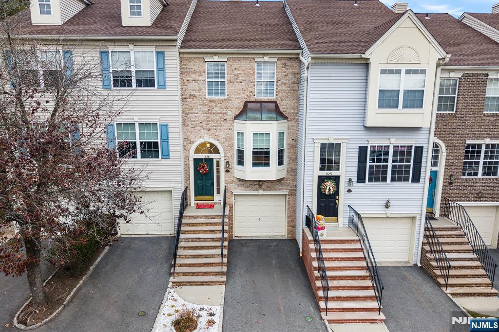 Set in the highly sought-after Georgetown enclave of Cambridge Heights, this tri-level townhome offers easy, comfortable living in a setting thatâ€™s impossible to beat. Sunlight fills the home from the moment you enter, highlighting the warm wood floors and a layout designed for both everyday living and entertaining. The eat-in kitchen is bright and functional, featuring generous counter space, updated appliances, and room to gather. The living and dining spaces flow effortlessly, centering around a cozy fireplace overlooking the greenery. Step outside onto your private deck and enjoy a rare view: mature trees, a winding creek and the pool area that blends seamlessly with the landscape. Both well-sized bedrooms and 2 full ensuite baths are tucked away upstairs at opposite ends, along with laundry right where you need it. On the lower level, a walk-out bonus room adds incredible flexibility - ideal as a family room, guest space, home office or whatever fits your lifestyle. Step outside to a peaceful patio, perfect for relaxing outdoors. Direct access to the 1 car garage adds everyday convenience. Residents enjoy a full suite of amenities including a swimming pool, fitness center, tennis courts, playground, and clubhouse. All of this without sacrificing an easy commute to NYC with multiple transportation options available, including a nearby bus stop. This home offers an exceptional low-maintenance lifestyle well suited for those seeking space, privacy and accessibility.