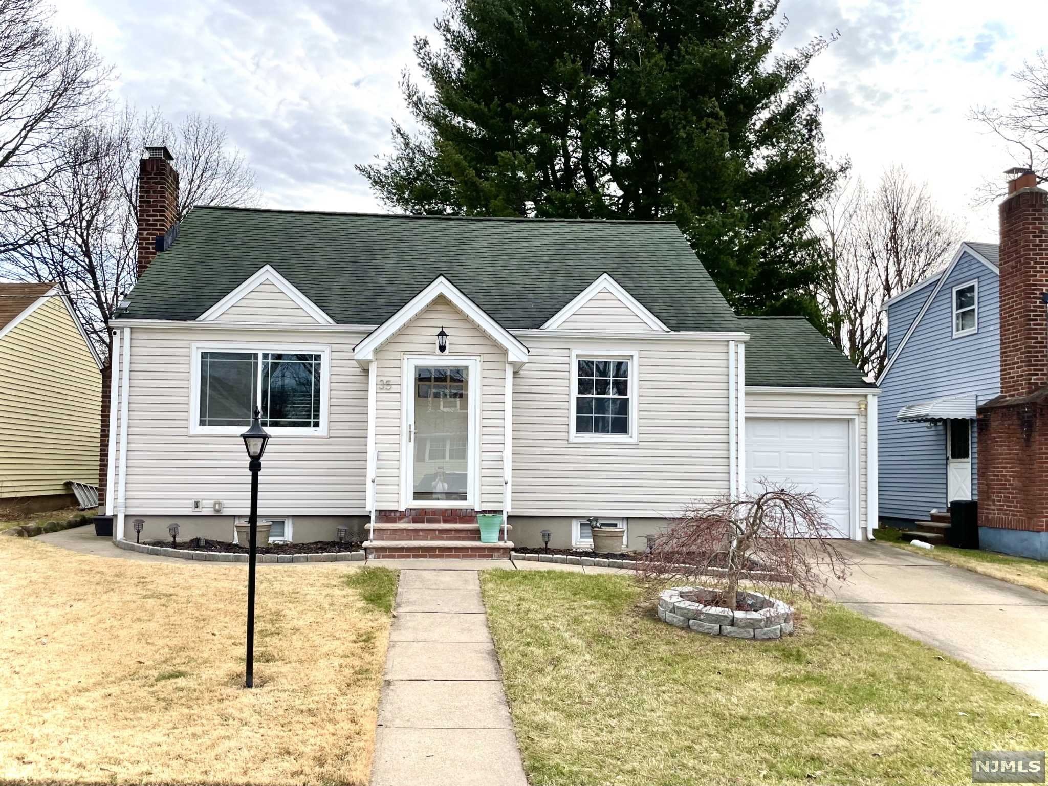 This tastefully renovated home in the Allwood section has it all! Entry foyer leads to a bright living room that features gleaming Brazilian Teak hardwood floors and wood burning fireplace. Ideal kitchen has been completely redone and features stainless steel appliances, 32in cherry cabinets, breakfast bar, designer backsplash and beautiful tile floor. Next to the kitchen is a sun filled dining room- windows galore!- that could easily fit a table for 12. Two large bedrooms on the first floor with windows that were replaced in 2015; a bathroom that offers high end tiles, marble shelves , and heated floors. Third bedroom can be found on the second floor with new floors. Partially finished basement can be made to accommodate your needs as well as featuring a laundry area. Long list of amenities include: six panel pine doors, attached garage, updated electric and plumbing, central A/C, high quality vinyl siding w/ insulation, new fence and much much more!