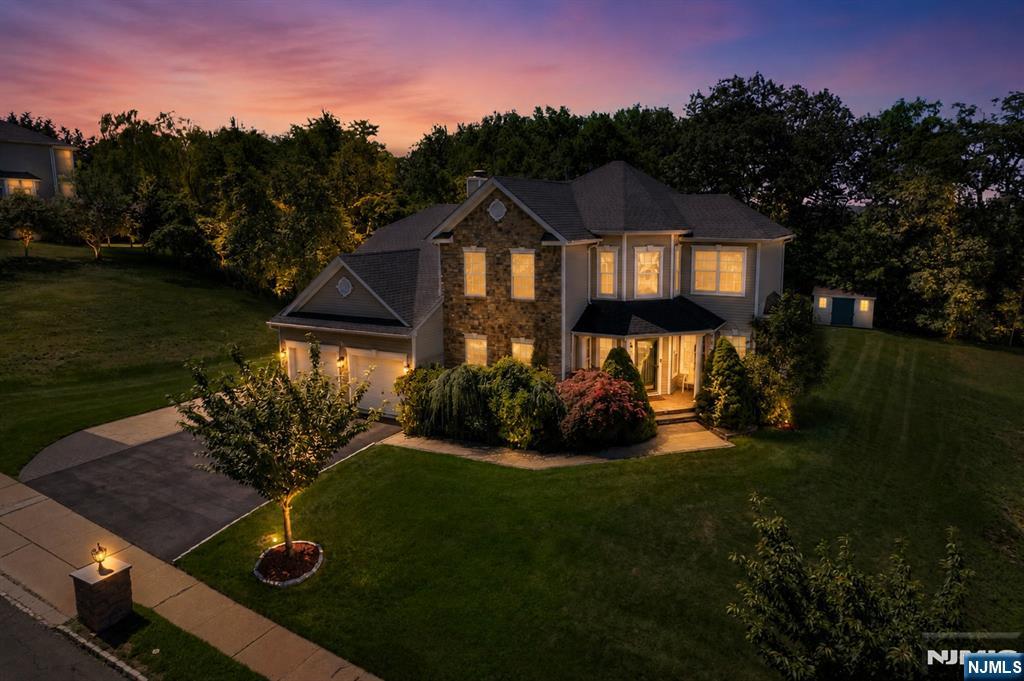 Luxury, privacy, and exceptional indoor-outdoor living define this beautifully updated residence in The Peaks, one of Morris County's premier luxury communities. Situated on a premium oversized lot backing to protected township land that cannot be developed, this exceptional home offers remarkable privacy. At the heart of the home is a designer chef's kitchen featuring a Wolf 6-burner range with vented hood and pot filler, Monogram double convection wall ovens with warming drawers, a paneled Monogram French door refrigerator, an under-counter double pull-out refrigerator, and a farmhouse sink with pull-down faucet, filtered water faucet, and soap dispenser. The open layout flows effortlessly into spacious living and dining areas, creating an ideal setting for everyday living and entertaining. Outside, enjoy professional landscaping, a custom paver patio, pergola, fire pit, and outdoor kitchen with built-in grill, wet sink, and refrigerator. The exceptionally flat backyard is a rare offering within The Peaks. The finished lower level offers expansive recreation space, abundant storage, and a second summer kitchen complete with a refrigerator, wine refrigerator, dishwasher, sink, and additional prep space. Residents enjoy tennis and basketball courts, playgrounds, scenic walking streets, beautifully maintained common areas, low HOA fees, and convenient access to shopping, major highways, NJ Transit, and New York City.