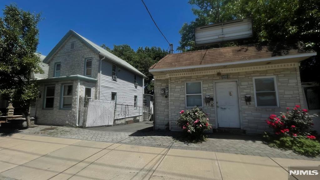 Rare fine/unique mixed-use property featuring two separate buildings on one lot. The residential building is a fully renovated single-family home offering a living room, eat-in kitchen, 3 bedrooms, and 1 full bath. High semi-finished basement with lots of potential. The second building is a free-standing commercial space with an unfinished basement, currently used as an office space. Off-street parking for 4 plus cars. Conveniently located near shopping, restaurants, schools, parks, public transportation, and major highways including Route 21, Route 3, and the Garden State Parkway. Great opportunity for an owner-user, investor, or business owner. This property can be sold together with the adjacent property (322 Cortlandt St) with the potential of a 12-unit development. Suitable for a savvy investor/developer.