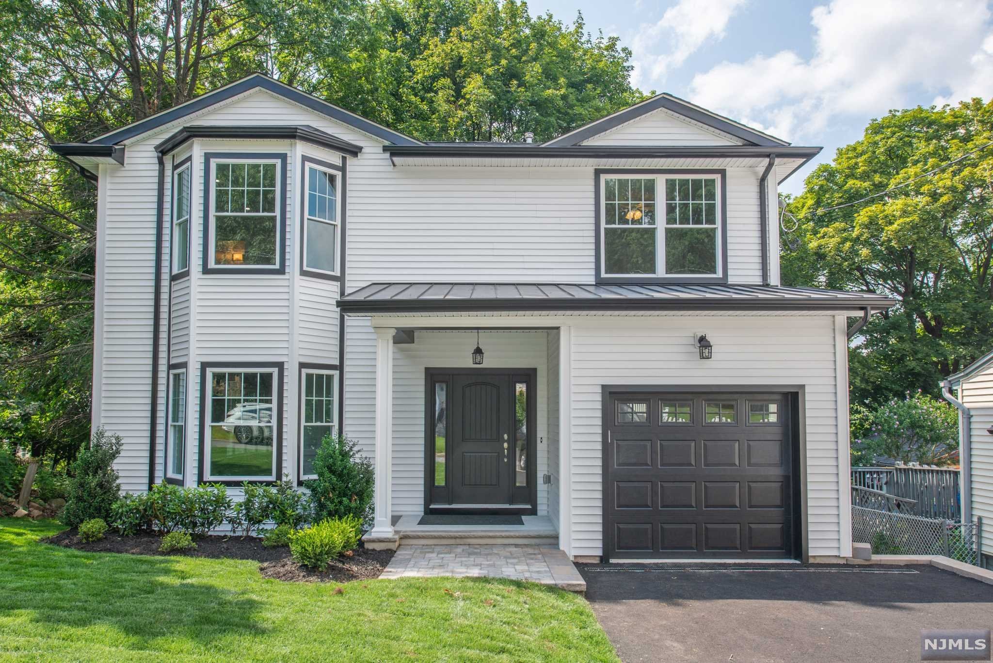 Beautiful New Construction in a great location. Just move right into this 4-bedroom, 2.5 bath, home featuring oak hardwood floors throughout, beautiful kitchen with breakfast bar, sliding doors that lead to a deck overlooking the backyard, a Beautiful Master BR with en suite bath, 3 more bedrooms and a main bath on second floor. Large attached 1 car garage and a full basement with 9-foot ceilings complete the home. Minutes from Rte. 80, 46, GS Parkway and only 20 miles to NYC. This modern new build is waiting for you to make it a home!