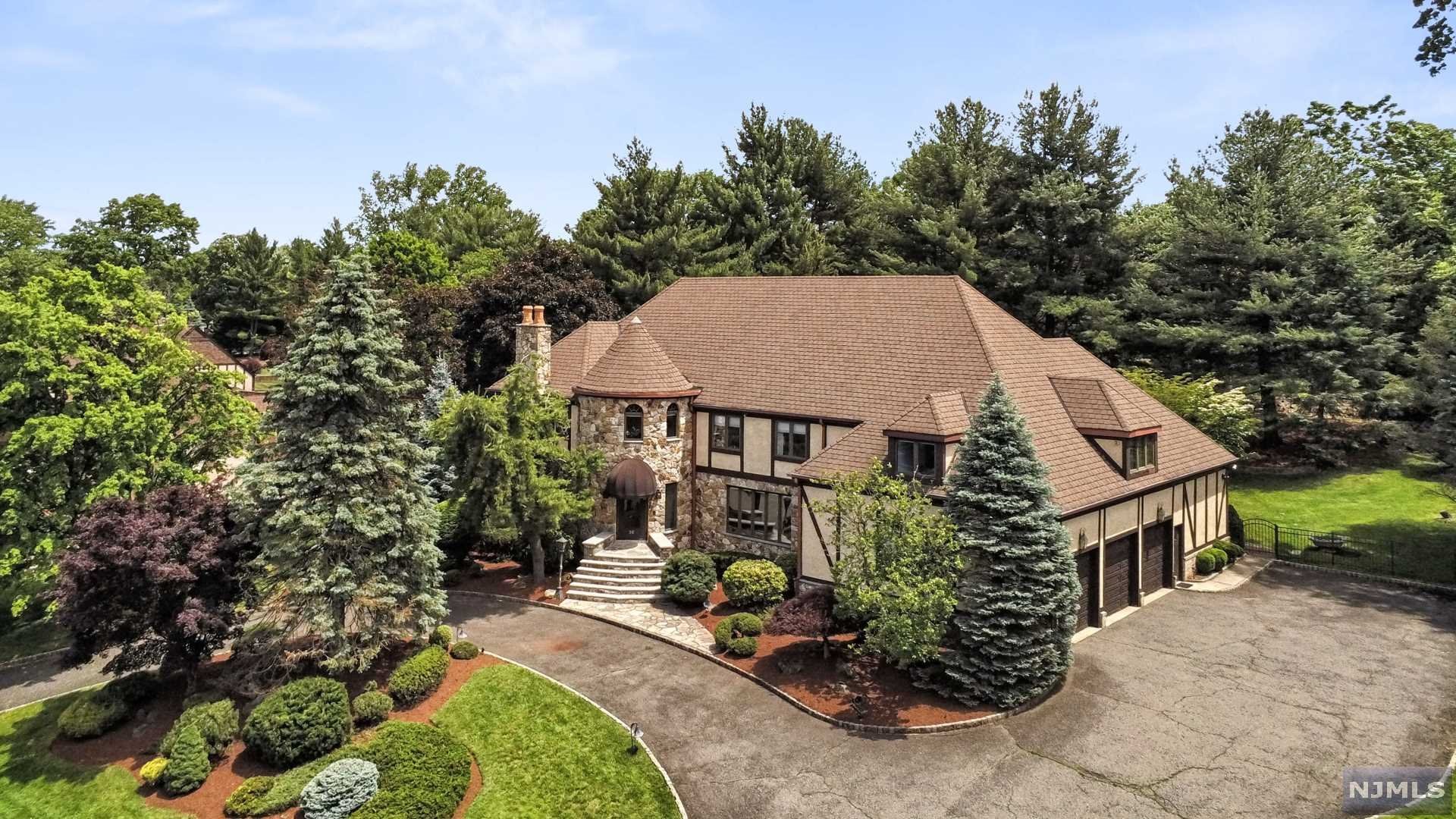 Prestigious Dey Hill Estates 6796 sq. feet of luxury w/5 Bedrooms and 4.1 updated Baths! Large foyer w/ grand sweeping staircase opening to a banquet sized Dining Rm and a sunken Living Rm w/wood burning fireplace. Breath taking Great Rm adorned w/vaulted beamed ceilings, 2 sided fireplace and wet bar leads to the more casual Family Room w/spiral staircase to loft. Enjoy panoramic vistas from the floor to ceiling windows t/o the main floor. EIK w/brkfst area provides access to patio w/awning and private manicured serene yard. Main flr; powder Rm and a full bath, mudroom, laundry and Bedrm. Luxurious MBS w/2 stunning en-suite baths /2 WIC plus a stone fireplace and sitting rm/office in the turret, 3 add'l Bedrms and main bath. All bathrooms have been renovated and masterfully designed with classic modern elements. Partially finished basement highlights a walk in wine cellar, bar & wine tasting rm. Features: hw flrs t/o, walk-up attic, greenhouse, 3 car garage w/circular driveway.