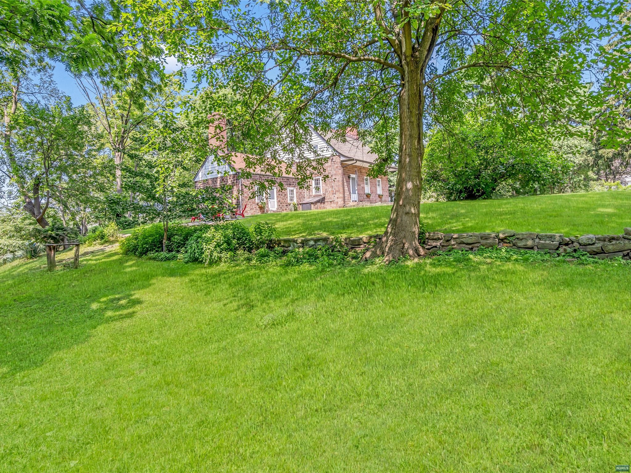 The John J Ackerman House Step back in time. This magnificent 18th century sandstone Colonial has been lovingly restored to excellent condition in keeping with the fine original Dutch architectural details that are found throughout this spacious sun filled 5 bedrooms, 2.5 bath home. If living and spending quality time relaxing in nature's beauty year-round is your idea of heaven on Earth, then this majestic home/property situated on a knoll high above the banks of the Hackensack River on more than 1.5 acres of parklike property is just what you have been waiting for. Imagine yourself dining al fresco on the private brick patio or sitting by the river enjoying your favorite beverage while watching the sunset, or fishing or kayaking from your own backyard all within a few miles from NYC. Special Features: Huge Custom Gourmet Kitchen with 2 sinks/2 dishwashers, quartzite/curly maple countertops, wide plank pumpkin pine floors, 2 car garage w/400amp/3phase power and much more!