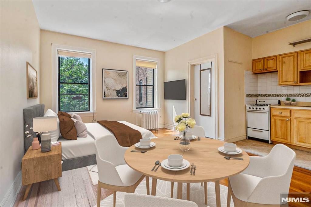 Welcome to this charming studio condo in the desirable Madrid building, just a short walk from the Journal Square PATH station perfect for commuters. This bright and inviting space features large windows that fill the home with natural sunlight, well-maintained hardwood floors, and a functional layout ideal for comfortable city living. Enjoy the convenience of being close to restaurants, shops, and transportation in one of Jersey City's most connected neighborhoods.