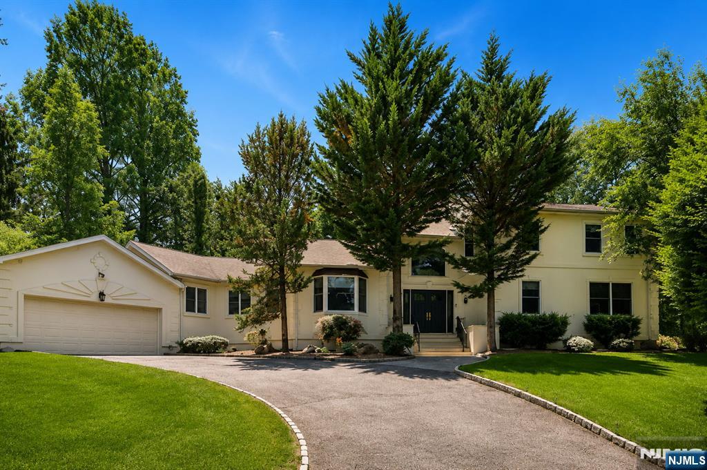 Welcome to an exceptional, fully renovated residence in one of Bergen County's most sought-after communities. Perfectly situated in the heart of Closter, this stunning 6-bedroom home seamlessly blends timeless elegance with today's modern lifestyle, offering a truly move-in-ready experience. A dramatic two-story foyer welcomes you into light-filled interiors where soaring ceilings, rich hardwood floors, and thoughtfully designed open living spaces create an atmosphere of warmth and sophistication. The spectacular chef's kitchen is the centerpiece of the home, featuring premium stainless steel Thermador appliances, custom cabinetry, 2 separate sinks with generous prep space, and an effortless flow into the dining area. The spacious living areas provide the ideal setting for entertaining while maintaining a comfortable everyday lifestyle. The first-floor primary suite comes complete with a beautifully appointed spa-inspired bath and an expansive walk-in closet. An additional first-floor bedroom provides exceptional flexibility for guests, extended family, or a private home office. Set on a cul-de-sac across from the Nature Center in an unbeatable location, this home is just moments from Closter's award-winning schools, vibrant downtown, parks, nature trails, and the renowned Closter Plaza. Easy access to New York City transportation, exceptional dining, shopping, and a community atmosphere make Closter one of Northern New Jersey's premier places to call home.
