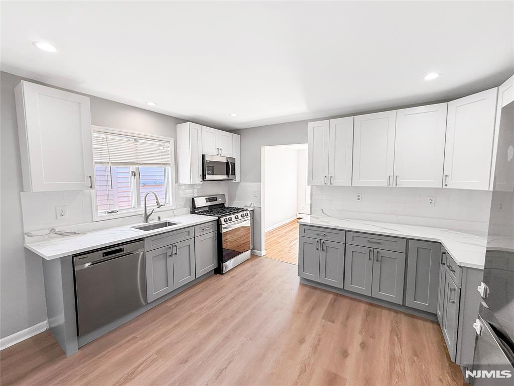 Sun-drenched and freshly renovated, this top-floor 3-bedroom, 2-bathroom home is the rare rental that checks every box: gorgeous views, in-unit laundry, off-street parking, and an express bus to NYC just one block away. Filled with natural light, this spacious apartment pairs modern finishes with everyday comfort. The thoughtfully designed layout features a large living room, generous formal dining room, gleaming hardwood floors throughout, and a stunning chef's kitchen with quartz countertops, custom cabinetry, and stainless steel appliances. All three bedrooms offer generous proportions and ample closet space, anchored by a king-sized primary suite with double closets and a sleek en-suite bathroom featuring a stall shower. The additional bedrooms comfortably fit queen-sized furniture and share a second, equally updated full bathroom. Additional highlights include wall-unit air conditioning, baseboard heating, abundant storage, and one off-street parking space included in the rent. Just moments from local shops, restaurants, and everyday essentials, this beautifully updated home delivers space, style, and an easy commuteâ€”the kind of place that doesn't stay on the market long, so schedule your showing today! Tenant is responsible for all utilities. Small pets considered on a case-by-case basis.