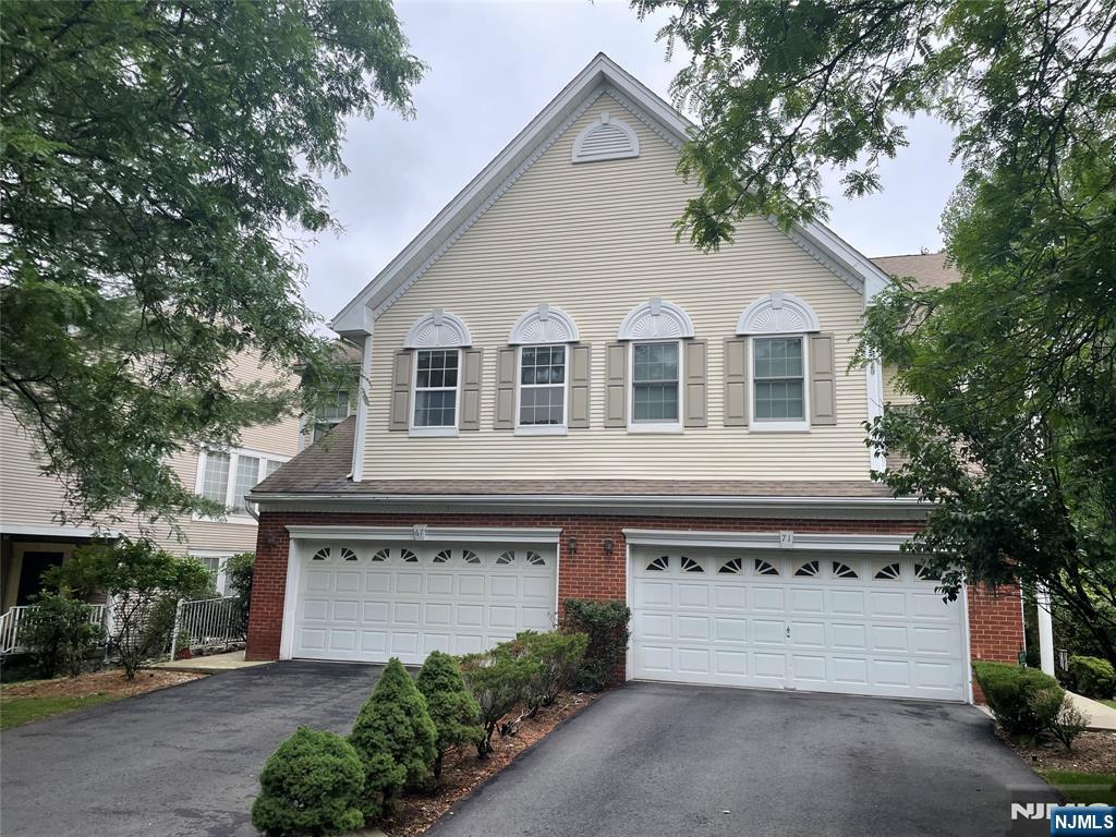 Experience the perfect combination of space, comfort, and natural beauty in this beautifully maintained 4-bedroom, 2.5-bath end-unit townhouse, ideally situated in one of Wayne's most sought-after communities. Filled with natural light, this home features soaring vaulted ceilings, hardwood floors (where installed), and dramatic floor-to-ceiling windows that showcase peaceful wooded views. The open-concept living and dining areas create an inviting atmosphere, while the spacious primary suite offers vaulted ceilings, a large walk-in closet, and an ensuite bath with a soaking tub, stall shower, and dual vanity. Three additional generously sized bedrooms, an in-unit laundry room, and abundant storage add everyday convenience. The full walk-out basement provides endless potential for additional living space, a recreation room, home gym, or office. Enjoy the privacy of end-unit living from your own deck overlooking beautifully landscaped grounds. Complete with a two-car attached garage and conveniently located near shopping, dining, parks, major highways, and NYC transportation, this exceptional home offers the lifestyle you've been looking for.