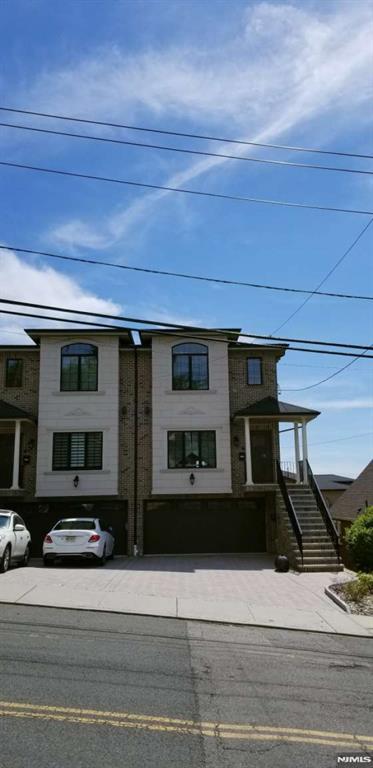 Welcome to the sweet home located on 304 East Palisades Blvd, Unit B. This beautiful duplex (built in 2015) features unobstructed, panoramic views that bring abundant natural light into the home throughout the day. Step inside to an expansive sun-drenched open-concept layout. The main level seamlessly connects the spacious dining area and a formal living space to a gourmet chef's kitchen, granite countertops, rich dark wood cabinetry, and stainless-steel appliances. Gleaming hardwood floors flow throughout. The home offers 4 bedrooms and 3.5 bathrooms with 2-car garages and up to 4-car parking spaces in a long, paved driveway. The fully finished ground level has tile floors, a full bedroom, and a full bathroom, which is ideal for use as a guest suite or home office. Additional highlights include multiple-zone heating, central air conditioning, and convenient access to NYC transportation, shopping, restaurants, and major highways.