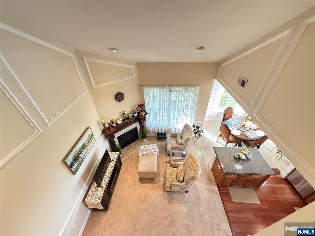 LIVE THE GRANDE LIFE! Best Location! Near clubhouse & pool. 1553 S.F elegance. Beautiful "Hickory Model" 4th flr 2 bedroom, 2 bath condo w/Loft. Cathedral ceiling! Private, quiet end unit. Peaceful views from all rooms. Featuring 2 bedrooms w/WIC in each bdrm. Two full baths! Kitchen w/ ctr island, granite, SS appliances, upgraded cabinets. Spacious LR w/gas FP. Separate dining area with plenty of windows and light. Spacious Loft which can be used as another bedroom, office or whatever your heart desires. Laundry rm accommodates full size W/D side by side! You will fall in love with this beauty! Amazing low Riverdale taxes only $8,058. Water heater only 2 years old. A/C only 4 years old. . One car garage assigned parking space underneath bldg. Plus add'l parking. Experience the Grande life with a wealth of amenities, including 2 clubhouses equipped with fitness centers, billiards rooms, conference rooms, party rooms, tennis and basketball courts, 2 swimming pools, and much more! Enjoy a fantastic location with easy access to major highways, shopping and restaurants. PET POLICY- MAX 2 PETS-35LB WEIGHT LIMIT PER PET.