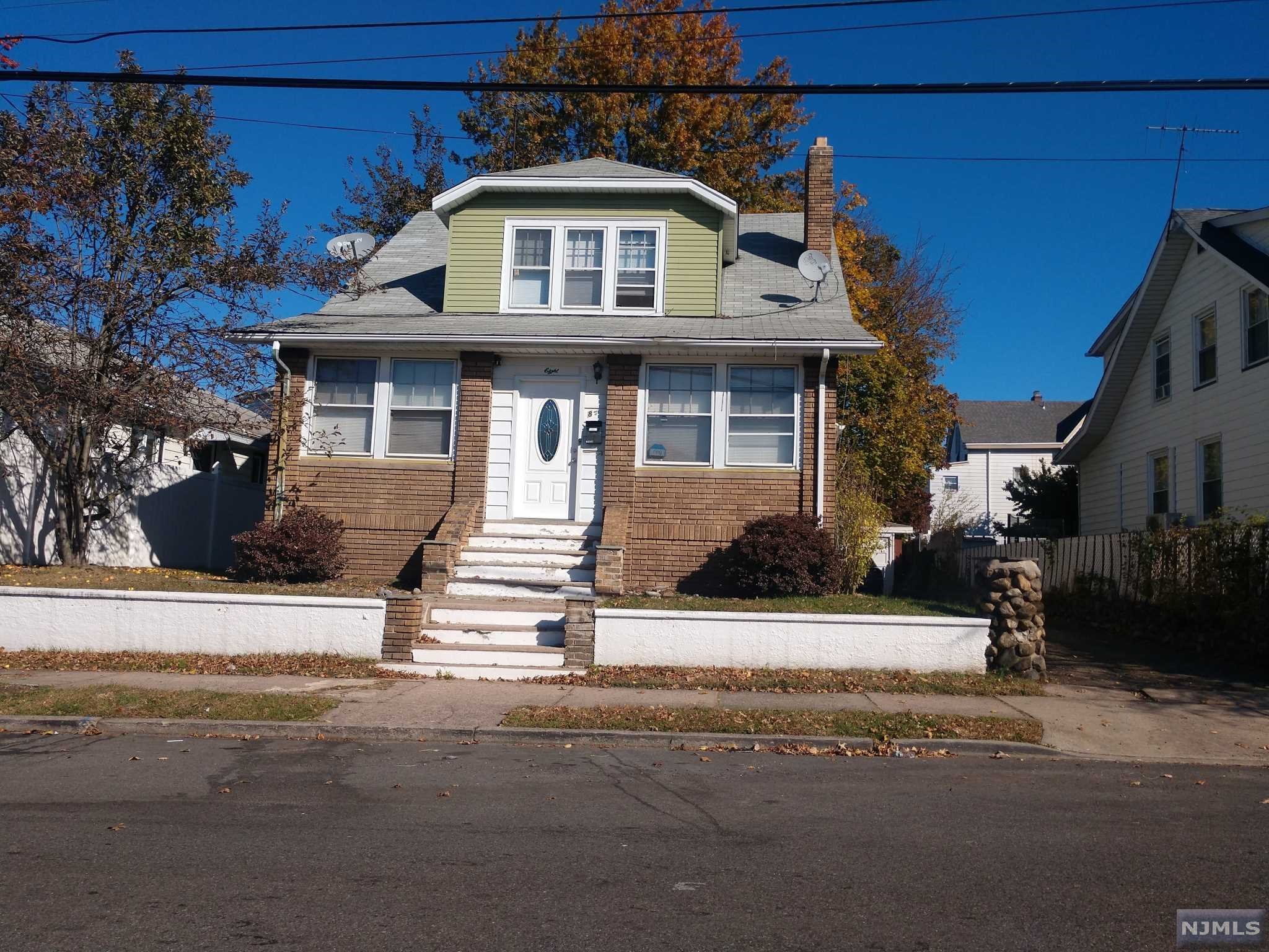 Two family home with so much to offer. First floor apartment has LR, Kit, 2 BR, Den, Finished basement, garage and driveway use of back yard. 2nd Floor has 1 large bedroom, Kitchen, Bath 2 walk-in closets. Use of side yard.