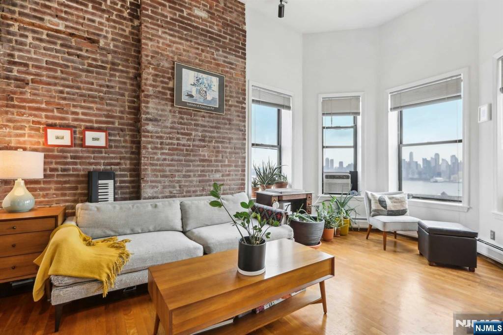 This beautiful 1-bedroom, 1-bathroom condo features sweeping north and south views of the iconic NYC Midtown skyline, filling the space with stunning natural light. The open-concept living area is ideal for both relaxation and entertaining. Plus, a creative loft space adds extra storage and versatility. This apartment is situated on the 4th floor, the top floor of this walk-up building. For your convenience, laundry is located in the building's basement. You're just 20 minutes from Manhattan, offering the perfect blend of NYC access and New Jersey tranquility. Don't miss this opportunity to own a home with exceptional views and modern convenience!