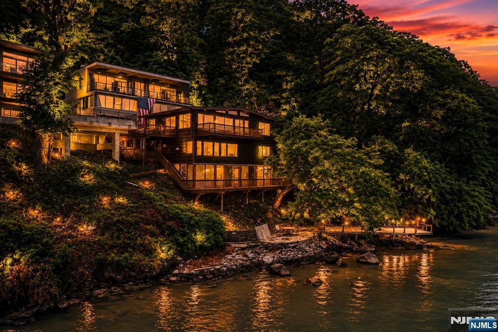 One of the Best Hudson River waterfront opportunities to hit the market in decades! Located in the exclusive gated Edgewater Colony, this beautifully renovated 3-bedroom, 2-bathroom waterfront cottage offers panoramic Hudson River and NYC skyline views, private dock rights, deeded parking, a 3-season gym/playroom, and a rare oversized lot with exceptional future building potential. Renovated throughout in the 2020s, the home features an open layout, updated kitchen with stone countertops and stainless steel appliances, renovated baths, and walls of windows overlooking the water. Enjoy boating, kayaking, paddle boarding, fitness center, and one of the Gold Coast's premier waterfront locations just minutes from Manhattan, with miles of scenic hiking and biking trails right outside your door. Don't miss the virtual tour featuring cinematic home and community videos, a Matterport 3D walkthrough, floor plans, photos, and additional property details. https://newjerseyproper.com/mls-35-shore-rd-edgewater-nj/