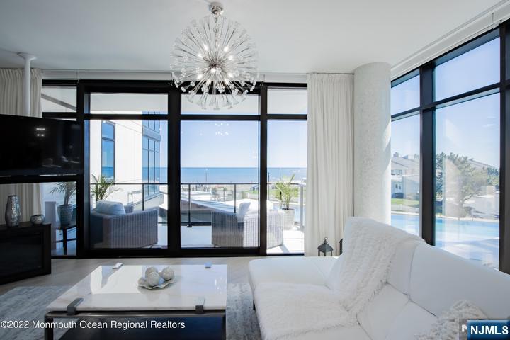 Wake up to breathtaking ocean views from this one-of-a-kind 3,309 sq. ft. oceanfront duplex offering an additional 865 sq. ft. of private outdoor living space. Watch dolphins swim by as every day feels like a vacation. A private elevator opens to this exceptional residence featuring 4 spacious bedrooms, 5 full baths with custom built-ins, and award-winning interior design. The luxurious primary suite offers custom his-and-her closets, radiant heated floors, and a freestanding soaking tub overlooking the ocean. Premium finishes include floor-to-ceiling custom glass, wide wood-look porcelain flooring, European wall panels, handcrafted columns, Woodhaven custom cabinetry, Calacatta Laza and Sparkle White quartz countertops, and Platinum Collection crystal chandeliers. The second level features three additional bedrooms, a family room with wet bar and kitchenette, and seamless access to a private courtyard with a hot tub, grilling station, and gas fireplace. Smart home technology includes hardwired internet, security, and facial recognition. South Beach offers resort-style amenities including a 7-day concierge, state-of-the-art fitness center, heated pool with sand deck and fire pit, private dining room with wine lockers, elegant great room, outdoor grilling areas, heated garage parking, private storage, bicycle room, two assigned parking spaces, and additional seasonal parking.