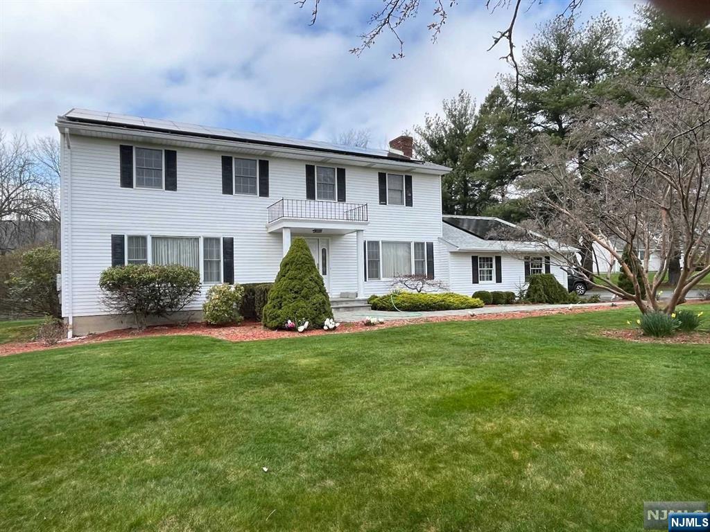 Beautifully maintained and landscaped colonial, w/ 4 Bedrooms, 2.5 Baths, LR and formal dining room, Lg Family Room w/Wood-burning fireplace; Wood flooring throughout entire home along with carpeting and tile. Four-season solarium off kitchen with access to rear deck and large level yard + koi pond; 2-car garage with loft storage and ample driveway parking. Solar energy panels over new roof. Great mountain views. Very desired neighborhood. Close to shopping, golf, skiing, water park, mountain biking; nearby Appalachian Trail, and easy access to other State Parks and outdoor activities. Come see it for yourself!