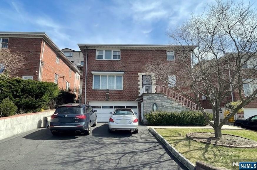 This bright and spacious 3-bedroom residence features beautiful hardwood floors throughout, a modern kitchen with stainless steel appliances, and central air conditioning for optimal comfort in every season. Enjoy the convenience of two dedicated driveway parking spaces and on-site laundry. Please note: no pets and no smoking allowed.