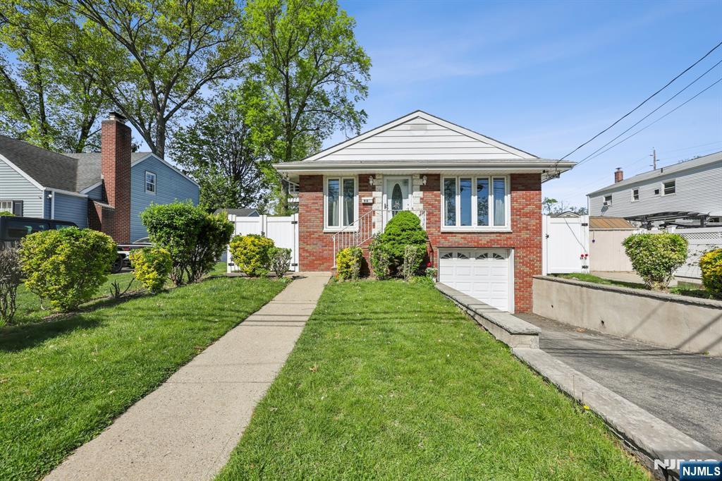 Welcome to this charming 3-bedroom, 2.5-bath home, ideally located on one of Bergenfieldâ€™s picturesque streets. Designed for easy one-floor living, the main level features a sun-drenched living room and formal dining area with gleaming hardwood floors and stunning floor-to-ceiling windows that fill the space with natural light. The beautifully renovated kitchen boasts sleek stainless steel appliances and modern finishes, perfect for everyday cooking and entertaining. The primary bedroom includes a private half bath, while two additional bedrooms share a tastefully updated full bathroom. Downstairs, the finished basement offers incredible versatility with a large recreation room, office space, full bathroom, and convenient laundry area. The attached one-car garage provides direct entry into the basement for added ease. Ideally situated just blockss from Cooperâ€™s Pond, the Bergenfield Library, schools, parks, and public transportation, this home also offers quick access to New York City and major shopping destinations. A wonderful opportunity to enjoy comfort, convenience, and a desirable location all in one. Gas heat, window/wall A/C units.