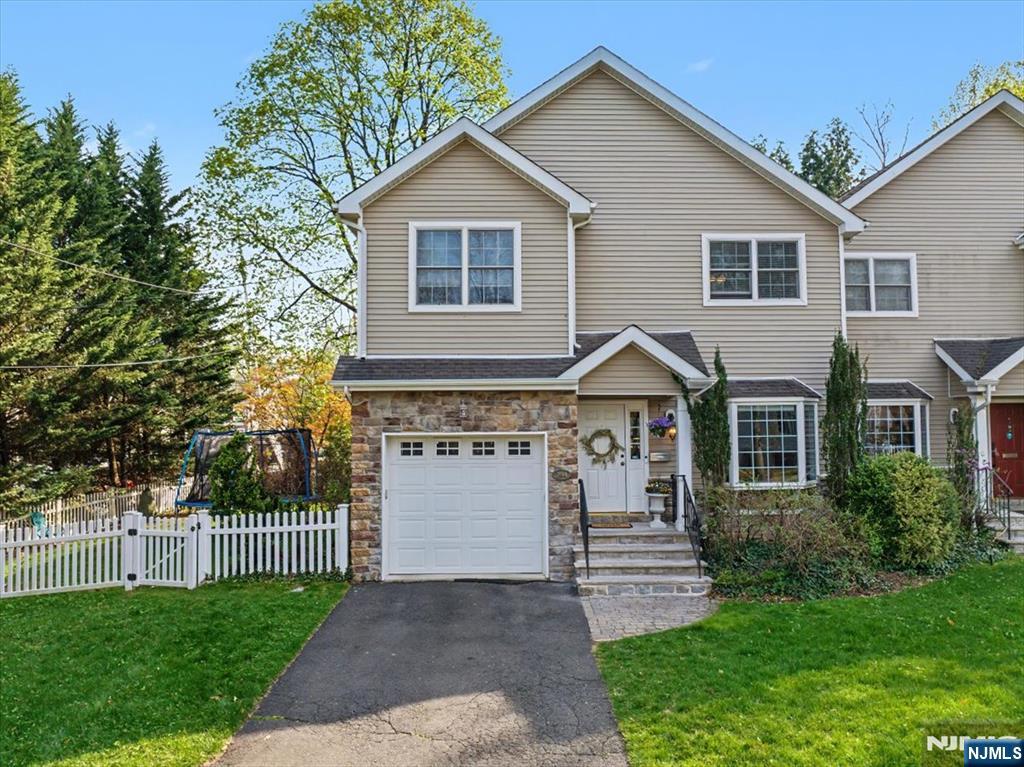 Welcome to the best of Ridgewood living where top-ranked schools, a vibrant downtown, and effortless commuting come together. Built in 2004 and beautifully maintained, this 3-bedroom, 3.1-bath custom attached home delivers modern style, generous space, and the low-maintenance lifestyle todayâ€™s buyers crave. Stroll just minutes to charming shops, standout restaurants, and direct train and bus service to New York City, a location that truly elevates everyday living. Inside, three levels of sun-filled space begin with an open main floor featuring 9-foot ceilings, gleaming hardwood floors, recessed lighting, and elegant crown molding. The spacious kitchen with stainless steel appliances flows seamlessly into the dining and family rooms, anchored by a cozy gas fireplace and doors to a private deck and fenced yard, perfect for entertaining or unwinding. Upstairs, retreat to a stunning primary suite with soaring cathedral ceilings, a walk-in closet, and a spa-like bath with double vanity, jacuzzi style tub, and updated shower. Two additional bedrooms, a full bath, and convenient second-floor laundry complete the level. The finished lower level adds incredible flexibility ideal for a home office, guest suite, or gym, plus a full bath and ample storage. With an attached garage, central vacuum, two-zone HVAC, and NO HOA fees, this is a rare opportunity to enjoy turnkey comfort in one of Bergen Countyâ€™s most desirable communities!
