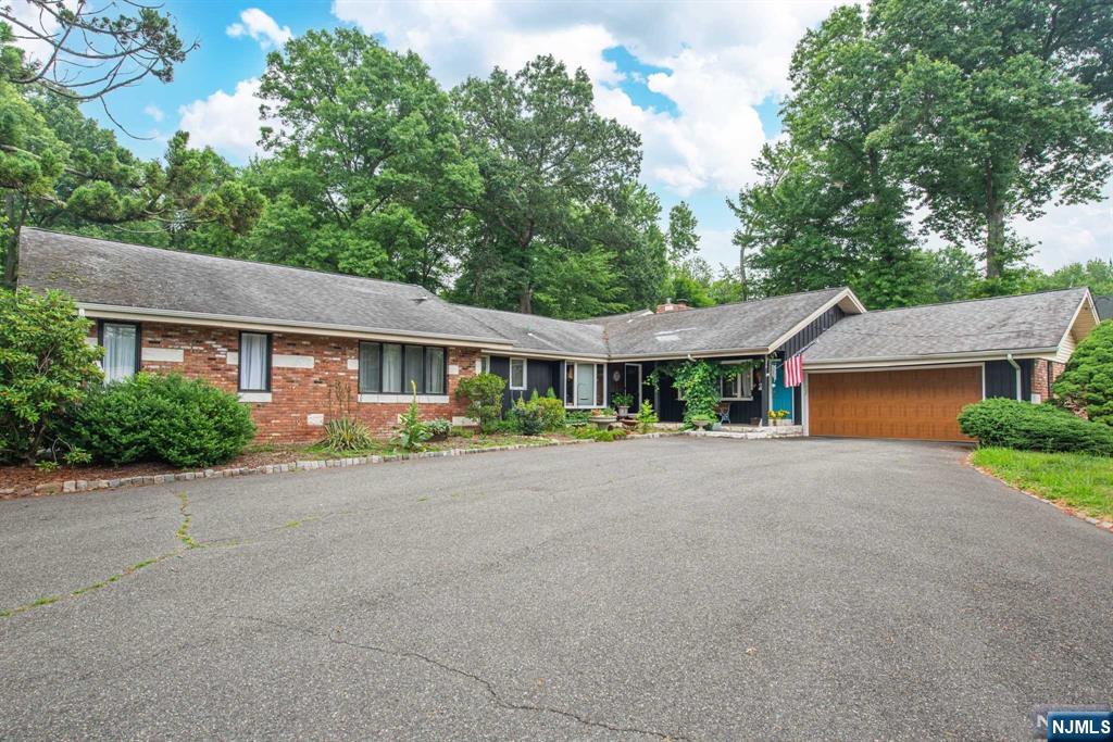 Unique & Rare! Property located on .67 acres of versatile space & endless possibilities in Montville Twp. Zoned for a variety of uses, this charming ranch-style home features one-level living w/ hardwood floors throughout. Sun-drenched living room, complete w/ a wood-burning limestone fireplace, flows seamlessly into the formal dining room, which opens onto a covered slate patio. Large eat-in kitchen boasts a separate dining nook, an oversized bay window & access to a 2nd patio, perfect for entertaining. A separate wing houses the primary bedroom w/ a full bath, along w/ 3 additional bedrooms & main bath w/ dual sinks. This home also includes a work studio or large family room w/ a private entrance & full bath, ideal for creative projects or a home office. The long driveway provides ample parking & the detached barn adds even more flexibility to the property. Enjoy the privacy of the expansive backyard & the convenience of a 2-car oversized garage. Close to major highways.