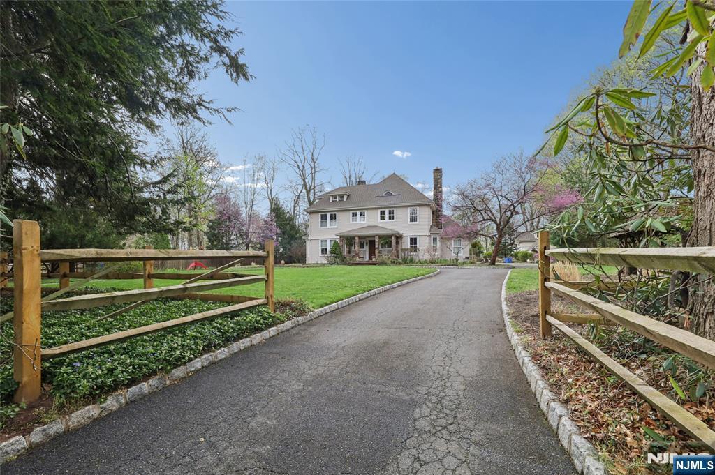 Fully renovated and beautifully preserved, this circa 1875 Georgian Revival estate is set on over 1 acre and offers a rare blend of timeless architecture and modern functionality. Set back from the road, behind mature hedges and blooming rhododendrons, the property features a graceful circular driveway, a vintage gazebo, a detached carriage house, and an additional groundskeeper's outbuilding. The 5 BR, 5.5 bath residence offers his and hers baths and dressing rooms, 2 laundry rooms, radiant heat, towel warmers, and 4 fireplaces. The stunning family room features a coffered ceiling and an entertaining bar with a built-in wine cooler. Gourmet kitchen includes honed Botticino marble island, Corian counters, 36" Sub-Zero refrigerator & freezer, Garland gas range, Thermador oven/microwave, 2 dishwashers, and 2 steel sinks. Marvin and Pella windows throughout. Renovated carriage house with skylights offers ideal studio, office, workshop, or creative retreat space. A truly one-of-a-kind Tenafly offering.