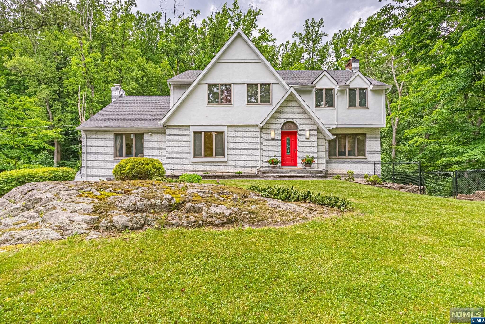 Immerse yourself in the tranquility of this spacious four-bedroom, 2.5 bath residence, generously situated on 1.46 acres of secluded paradise. A true gem, this home exudes a perfect balance of comfort and refinement, offering a full finished walkout basement for added versatility and relaxation. Upon entry, be greeted by an abundance of natural light that dances gracefully throughout the expansive living spaces, creating an inviting and open atmosphere. The updated bathrooms showcase modern sophistication, adding a touch of elegance to this serene abode. Indulge in seamless entertaining as you host guests in the generously sized living areas, designed to accommodate social gatherings or intimate gatherings with ease. Escape to the private flat backyard, enveloped by lush trees, offering a peaceful and outdoor haven for entertaining your guests.