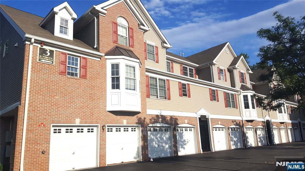 Welcome to this beautifully updated, turn-key townhouse offering 1,535 square feet of modern living space. The bright, open-concept layout is accentuated by soaring high ceilings, elegant hardwood floors, and contemporary recessed lighting throughout. Unwind in the expansive primary suite, featuring a generous walk-in closet and a large, spa-like bathroom. Luxury meets convenience with central heating and A/C, an in-unit laundry room, and abundant storage space. This unit includes one attached garage space plus one assigned outdoor parking spot. You will enjoy immediate access to major highways including Routes 95, 46, and 80. Best of all, it is within short walking distance to the NYC Express bus stop, making your commute an absolute breeze.