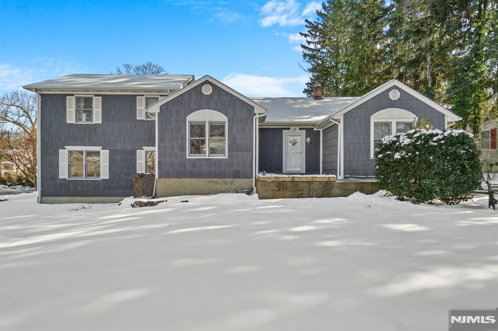 Welcome to 26 Woodside Avenue, on one of Midland Parkâ€™s most desirable streets! This freshly painted expanded Ranch offers comfort and convenience. The first floor boasts hardwood floors, built-ins, a formal dining room, living room, and modern eat-in kitchen. Flexible spaces allow for different uses of the first-floor bedrooms, including an office, sitting room, or guest room. Just a few steps off the living room is a spacious 14â€™ x 16â€™ primary bedroom with carpeting, two double closets, a full bath, and laundry. Prefer your primary bedroom upstairs? Thereâ€™s another 14â€™ x 16â€™ bedroom with two sets of double closets and a bonus storage area. Downstairs, thereâ€™s a recreation room with a cozy wood-burning stove and a bonus kitchenette, perfect for multi-generational living or gatherings. A two-car detached garage with a screened-in area is great for outdoor dining. So close to schools, parks, and downtown. Hurry, this wonâ€™t last!