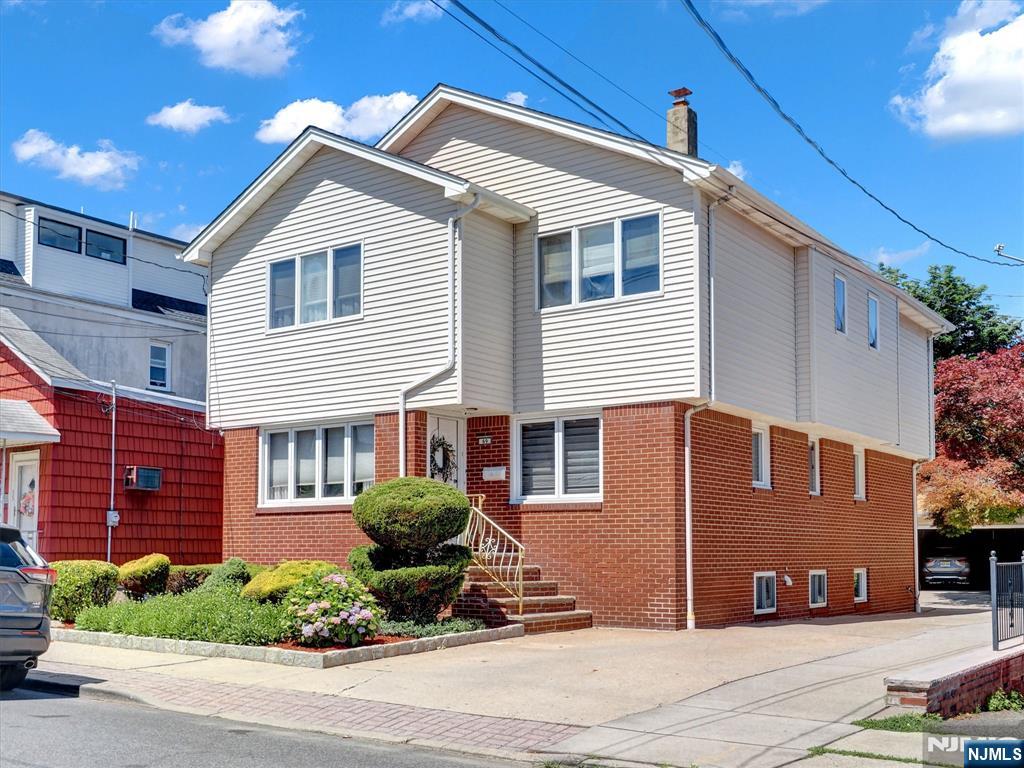 Welcome to this spacious and versatile two-family home in the heart of Fairview! The owner-occupied main unit offers an impressive 5 bedrooms and 3 full baths. The first floor features a large living room, formal dining room, modern eat-in kitchen with stainless steel appliances, bedroom, full bath, and a bonus media room currently used as a cigar lounge. The second floor includes 4 additional bedrooms and 2 full baths, highlighted by a spacious primary suite with a private bath and walk-in closet, plus a convenient laundry room. Designed for comfort year-round, the home features two-zone central air conditioning and two-zone heating. The owner also enjoys access to a large basement storage area, providing exceptional space for seasonal items, tools, and household storage. The second unit is a generously sized studio apartment featuring an updated kitchen and full bath, ideal for rental income, extended family, or guest accommodations. Long driveway accommodating 6+ vehicles, a detached oversized 2-car garage, and a beautifully finished paver backyard perfect for entertaining. Conveniently located near schools, parks, shopping, restaurants, and public transportation, with an easy commute to New York City. A rare opportunity offering space, flexibility, modern amenities, and exceptional parking in a highly desirable Bergen County location.
