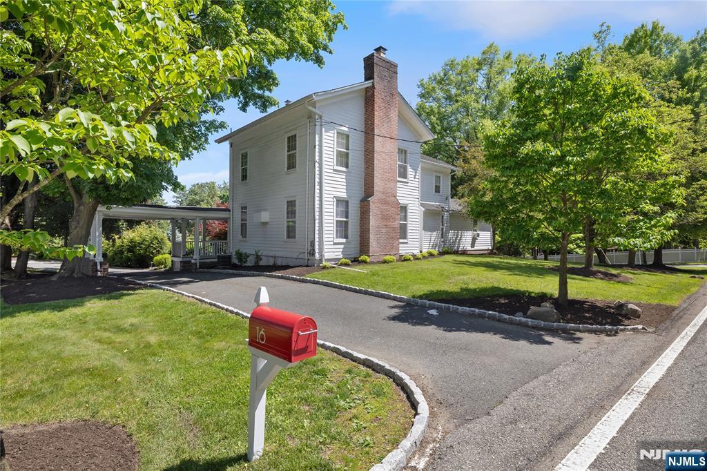 Set on a large corner lot, this architecturally striking Modern Farmhouse has been thoughtfully elevated for today's most discerning buyer. This custom residence delivers the stately character of a Ridgewood Historic home alongside upscale amenities the modern lifestyle demands. From the dramatic entry, soaring proportions & oversized windows set the tone immediately. East-west exposure ensures bright, shifting light throughout the day, & the open floor plan moves w/effortless grace between grand formal spaces & warm gathering rooms. The exquisite fpl anchors an expansive living room; a formal dining room flows naturally into the family room, creating a connected suite that feels both impressive & genuinely livable. At the heart of the home, a renovated center island kitchen w/custom cabinetry, granite countertops, & stainless appliances frames a cinematic view of the rear yard & in-ground pool through an oversized picture window. A butler's pantry bridges kitchen & dining room w/quiet practicality. Upstairs, a primary suite offers a private sanctuary w/dedicated bth & dressing area, joined by three additional spacious bedrms. Outside, an in-ground gunite pool anchors lush, private grounds. Two covered porches invite long summer evenings. The summer kitchen has direct rear yard access & the detached 2+car garage provides abundant storage. Top-rated schools. Direct NYC bus & rail connections make the city effortlessly accessible. A location that rarely becomes available.