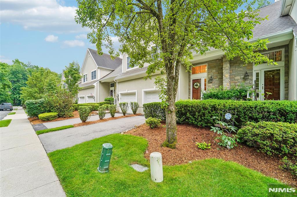 Welcome to Summit Ridge, a sought-after townhouse community nestled in the heart of Montvale. This 2-bedroom, 2.5-bath townhouse offers more than 1,900 square feet of beautifully designed living space, combining comfort, style, and convenience. A light-filled two-story foyer welcomes you into an open, spacious living and dining area that features a cozy gas fireplace and direct access to a private paver patio overlooking a tranquil wooded backdrop, creating the perfect setting for outdoor relaxation. The well-appointed kitchen offers ample cabinetry, generous counter space, and an eat-in area with a pass-through counter that seamlessly connects to the main living space. Upstairs, the primary suite boasts a vaulted ceiling, a walk-in closet, and a spa-like en-suite bath. A second generously sized bedroom and an additional full bathroom to complete the upper level. The finished lower level offers exceptional flexibility, featuring a spacious family room, home office, laundry room, and storage. Ideally located near shopping, schools, dining, and everyday conveniences, including The Shoppes at DePiero's, Wegmans, Whole Foods Market, and Tice's Corner, this exceptional home offers the perfect blend of peaceful community living in a prime location.