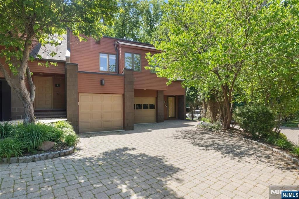 Welcome to this mint turn key townhome at Oak Trail, one of Englewood's most sought after townhouse gated communities with a pool and tranquil grounds. This beautifully renovated home combines modern comfort with timeless elegance, offering soaring ceilings, abundant natural light, and a spacious open concept layout designed for both everyday living and entertaining. The dramatic living room features vaulted ceilings and a gas fireplace , creating a warm and inviting focal point ,flowing seamlessly into the dining area and renovated kitchen . The renovated kitchen showcases custom cabinetry , quartz countertops and modern appliances, creating a functional and inviting space for cooking and gathering. The primary bedroom is a true oasis , offering privacy, spacious custom walk in closet and spa like bath. Upstairs family room with gas fireplace and deck overlooking the grounds and second primary suite with contemporary fixtures and tasteful design provide a fresh, move-in-ready experience. Step out from the living room to your own private landscaped patio providing the perfect setting to relax, unwind or enjoy morning coffee surrounded by the mature landscaping that makes Oak Trail so desirable. This townhouse has a two car heated garage and basement for ample storage. Enjoy the convenience of low maintenance living in a tranquil park like setting just minutes to New York City Transportation, houses of worship and downtown Englewood.