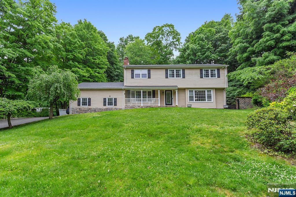 Refined design, impressive scale, and true pride of ownership define this impeccably maintained 4-bedroom, 4-bath Center Hall Colonial. Beautifully updated and freshly painted throughout, this expansive home offers a sun-filled layout with gleaming hardwood floors and effortless flow for everyday living and entertaining. The main level features a gracious formal living room, elegant dining room with access to the outdoor patio, and an inviting family room. At the heart of the home is a stunning eat-in kitchen with granite countertops, updated stainless steel appliances, an oversized peninsula, extensive cabinetry, and exceptional prep space. Upstairs, four generously sized bedrooms provide abundant natural light, including an impressive primary suite with a walk-in closet and spa-inspired bath. The finished lower level adds incredible flexibility with a full bath, expansive recreation space, dedicated office/den, plus separate utility and storage areas. Outdoors, enjoy beautifully landscaped grounds with a paver patio, mature greenery, and a tranquil water feature. Additional highlights include central air, baseboard heat, and an oversized 2-car garage with separate backyard access. Ideally located near shopping, dining, schools, and everyday conveniences, this move-in ready home combines timeless style, exceptional space, and modern comfort.