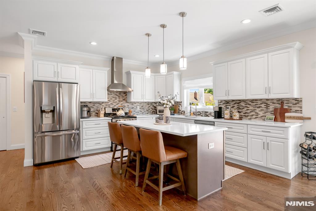Discover pure luxury in this stunning, recently constructed 4 Bedroom / 2.2 Bathroom Colonial located in highly sought after Saddle Brook. Situated on a 60 X 100 lot on a quiet street, this home features only the finest finishes including an open concept layout, gleaming hardwood floors throughout, central AC / forced hot air heat, two car garage, and a beautiful front porch. First floor includes entry foyer, living room / dining room combo, stunning Chef's kitchen w/ sliders to backyard, half bath, storage, and garage entrance. Beautiful Chef's kitchen includes SS appliances, quartz countertops, custom cabinets, and large center island. Second floor features a resort-like Master suite w/ two custom walk-in closets and gorgeous ensuite bathroom, three spacious bedrooms, full bathroom, and laundry. Finished basement includes rec room, gym, half bathroom, and utilities/storage. Completing this lovely home is a beautiful backyard with two patios and jacuzzi. Located near public transportation, award winning schools, parks, restaurants, major highways, and shopping, this is truly a home you do not want to miss!