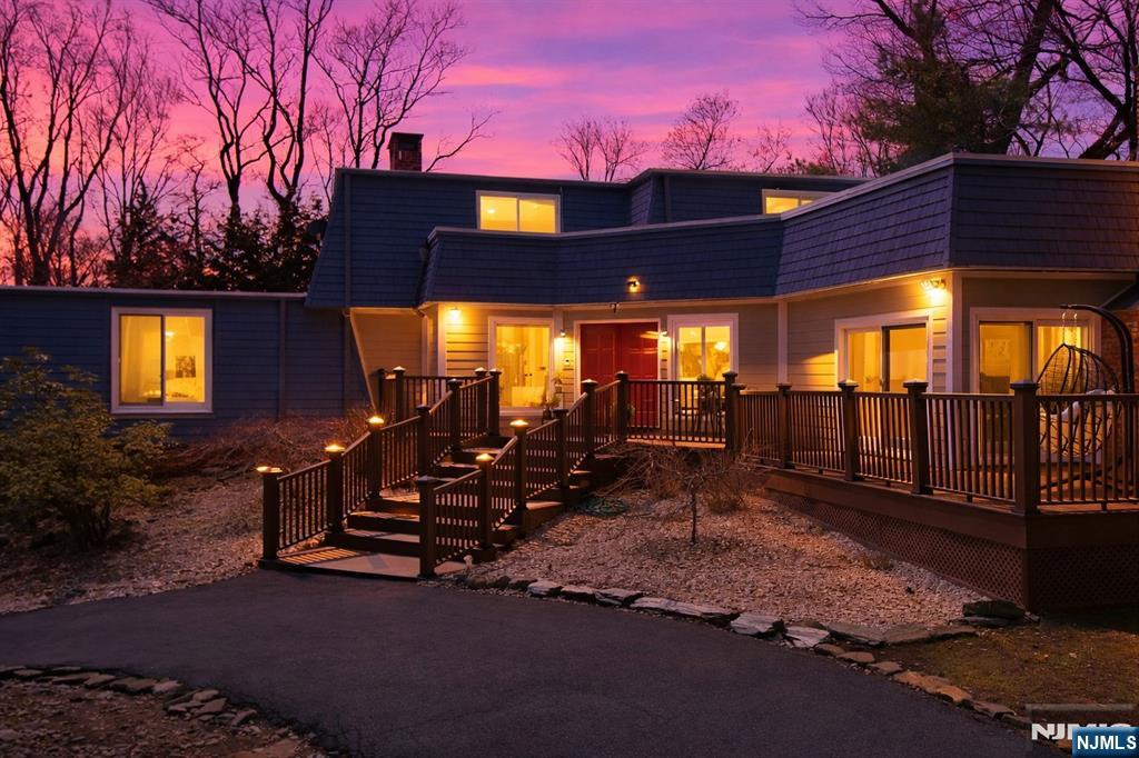 Tucked away in one of the most sought-after pockets of Urban Farms(Market Basket), this exceptional residence offers a rare blend of privacy, space, and timeless appeal. Set back from the main road on over an acre of beautifully secluded property, the home welcomes you with an expansive circular driveway and a sense of quiet sophistication. Offering over 3,650 square feet of living space, the interior is thoughtfully designed for both comfortable everyday living and elegant entertaining. A stunning great room with soaring 11-foot ceilings serves as the heart of the home, complemented by two fireplaces that add warmth and character throughout. The first-floor primary suite provides convenience and privacy, while three additional bedrooms offer flexibility for a variety of living arrangements.. Multiple gathering spaces enhance the home's versatility, and abundant sunlight fills every corner, highlighting its inviting and airy layout. A charming wraparound porch embraces the property, creating the perfect setting to enjoy the peaceful surroundings and natural beauty that define this special offering. A true retreat in a premier location where classic design meets the tranquility of refined suburban living.