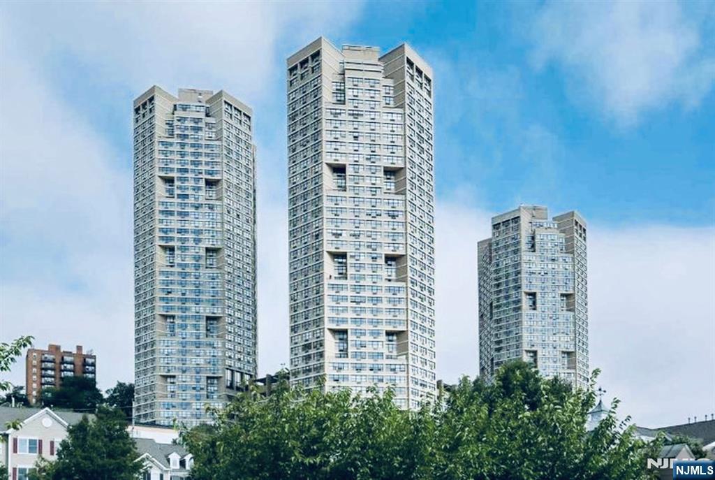 Luxury living awaits at the iconic Galaxy Towers! This beautifully renovated 2-bedroom, 2.5-bath residence offers approximately 1,809 sq. ft. of elegant living space with breathtaking panoramic views of the Hudson River, Manhattan skyline, and George Washington Bridge. Filled with natural light from its desirable eastern exposure, the open-concept layout is perfect for everyday living and entertaining. The updated custom kitchen features granite and limestone finishes, a center island, stainless steel appliances, ample cabinetry, and abundant storage. Hardwood floors flow throughout the home, complemented by freshly painted interiors, custom built-ins, oversized closets. The luxurious primary suite boasts a spa-inspired marble bath with a soaking tub, oversized glass shower, and generous closet space. An additional bonus room provides the perfect space for a home office, guest room, nursery, or den, offering flexibility to suit your lifestyle. Galaxy Towers offers resort-style amenities including 24-hour concierge and security, indoor and outdoor pools, a state-of-the-art fitness center, tennis courts, game room, children's playroom, and beautifully maintained common areas. Maintenance includes heat, hot water, gas, electricity, A/C, and full access to all amenities. Garage parking is available for just $120/month. Conveniently located with NJ Transit bus service at your doorstep and easy access to the NY Waterway Ferry, providing a quick commute to Manhattan.