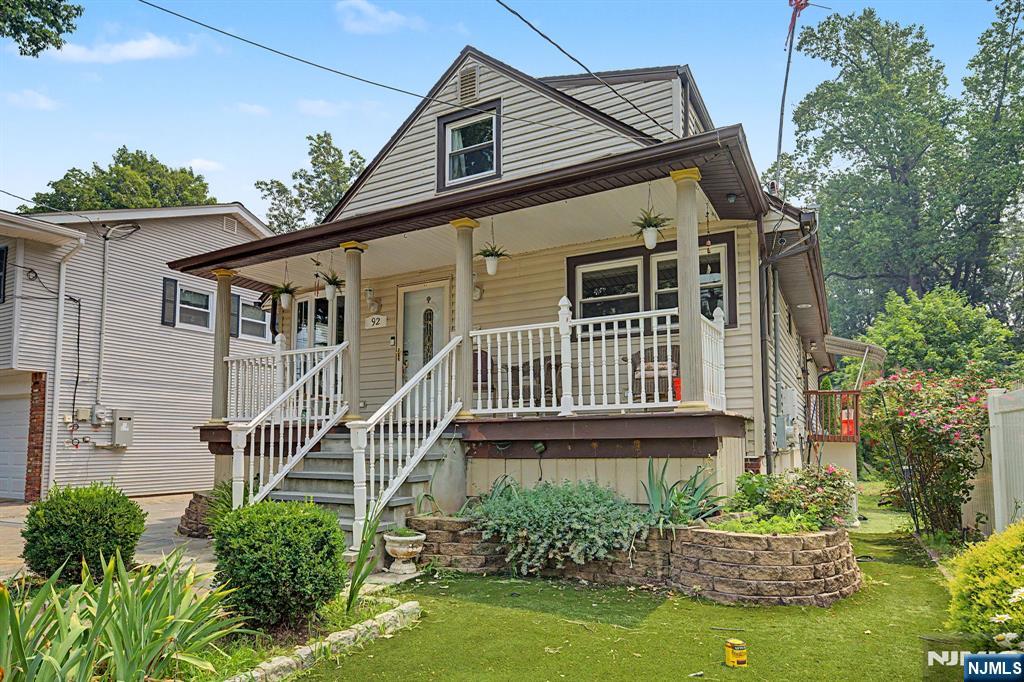 A rare find in Bergenfield. Welcome to 92 Blauvelt Ave, a custom Cape set on an oversized double lot offering space, flexibility and possibilities that are hard to find. Relax on the lemonade porch before stepping inside to gleaming tile and hardwood floors, a living room, dining room and modern kitchen with stainless steel appliances. The main level primary bedroom features cathedral ceilings, a private bath with skylight and access to a balcony. Upstairs offers two additional bedrooms and a half bath. The fully finished basement adds even more space with a bedroom or entertainment room, utility and storage areas, room for a gym and an additional bonus room with sliders opening to the oversized property. A large detached one car garage, expansive parking area and bonus office or storage space above complete this unique property. Enjoy the convenience, shopping, dining and NYC transportation that continue to make Bergenfield a popular place to call home. For more information on this home please contact Andrew Delgado- 347-502-8546