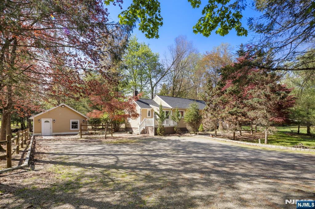 Excellent location surrounded by significantly higher-value homes. This well-maintained 3 bed rm 2 full bath ranch home offers endless possibilities and the opportunity to build your dream mansion. On approx. 1 acre in a desirable, peaceful setting with excellent blue ribbon schools, dining, shopping and recreation. Hardwood floors throughout the house. Recent upgrades including new heating system, new well and whole house is freshly painted. The property features an exceptional bonus studio apartment with kitchenette, full bath and separate entrance. Ideal for guests or rental income opportunities. This is a true gem!