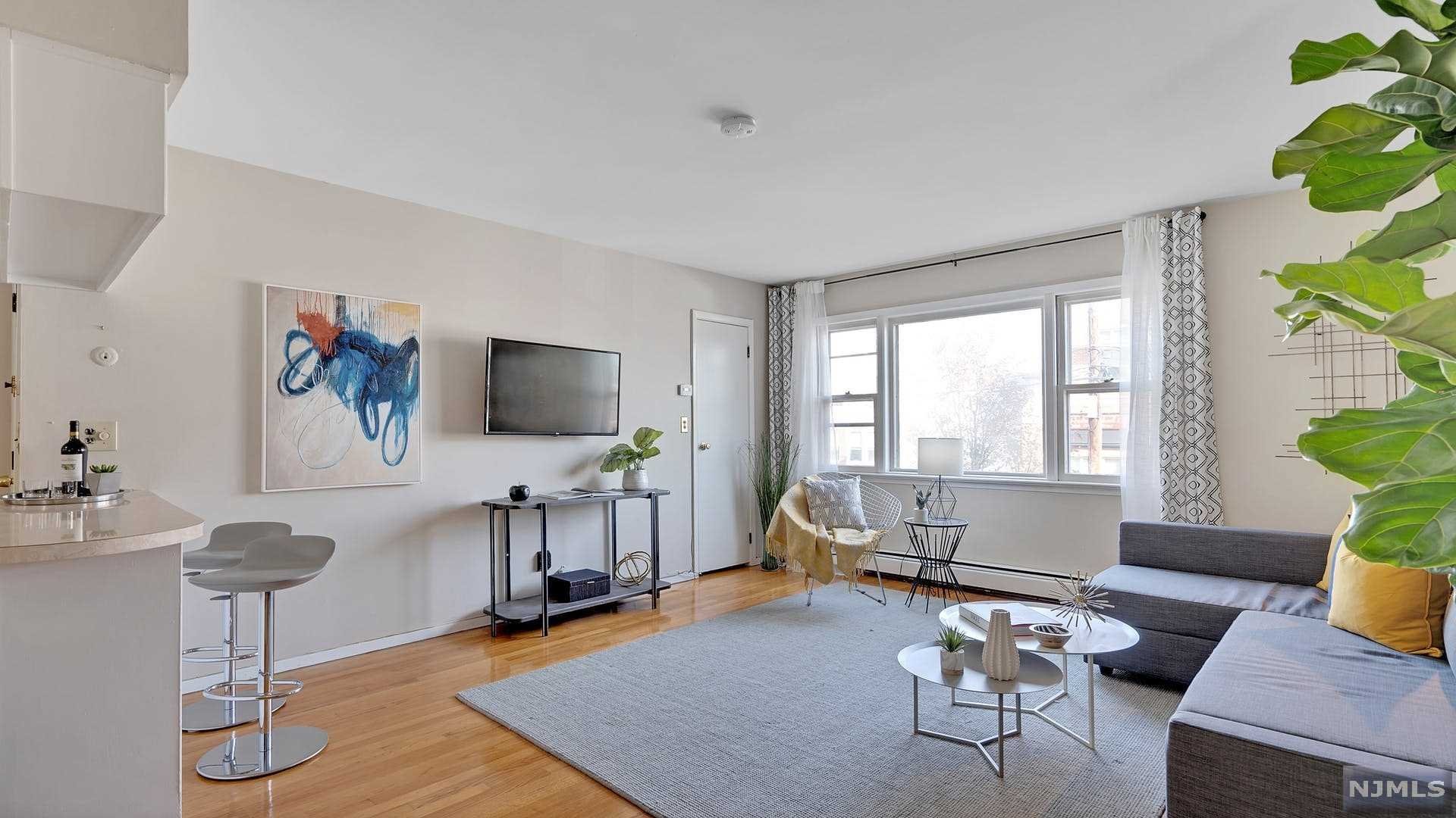 Perched high on the cliffs of West Hoboken, in the most magical area of Union City, this well-maintained 2-family occupies an unusually deep 21'x141' lot! The top-floor unit features 3 bedrooms, a sun-soaked living room with partial views of Manhattan skyscrapers, a meticulously updated bath with new fixtures and Spanish tiles, huge main bedroom with his and her closets, eat-in kitchen with lots of cabinetry and a separate dining space. The garden unit consists of 1 bedroom with an open floor plan, a bright bedroom facing the lush backyard, modern kitchen, large living/dining area, contemporary European-style bathroom and fresh wide-plank flooring. Private attached garage, hardwood floors throughout, baseboard gas heat, separate washer/dryer room and a massive oasis-like yard. Coveted, quiet neighborhood close to Palisade Ave, shopping, restaurants, and NYC Buses (just a 12-minute trip to Port Authority), close proximity to Hoboken, Weehawken and Jersey City.