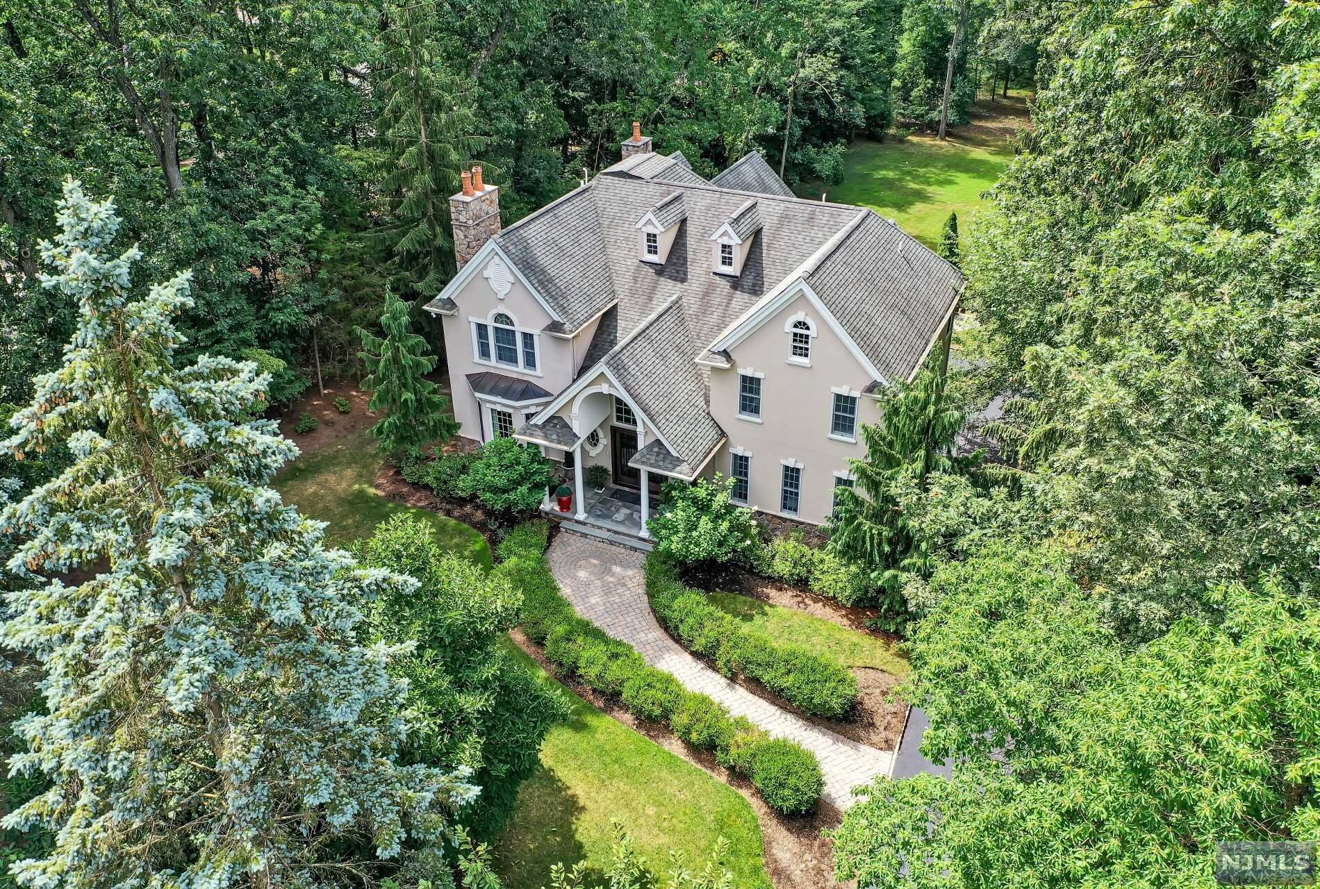 Architectural Elegance! Exceptional home set on tranquil property with waterfront access to Upper Blauvelt Lake. 2 story foyer with sweeping staircase, custom millwork & marble floors. Exquisite living room with fireplace, detail trim & circular accent windows. Grand french doors lead to banquet sized dining room. Glorious great room with high ceilings is drenched in light, 2nd fireplace, Palladian windows & door to deck. Butlers pantry opens to dazzling chefs kitchen with 2 center islands, dining area, marble floors & counters, glass backlit cabinetry & door to expansive deck overlooking property with lake views! Warm, inviting library is enhanced by floor to ceiling windows. Powder rm off foyer. 2nd floor showcases a balcony overlooking foyer. Primary suite features French doors to balcony, tray ceiling, 2 WIC, luxurious bath. 3 additional bedrooms & 2 full baths. Finished walkout lower level has family rm with 3rd FPLC, bath, rec room, mudroom, possible wine rm. 3 car garage