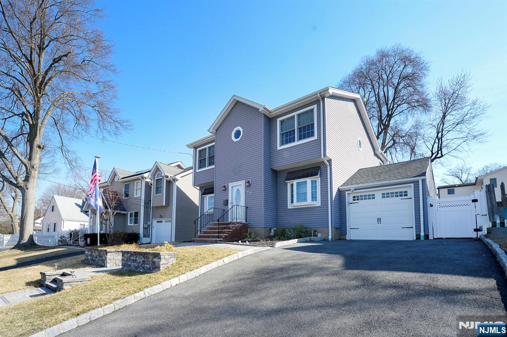 Expanded center hall colonial situated on one of Dumont's prettiest streets! Enter into foyer, oversized light and bright living room, huge formal dining room perfect for entertaining. Gorgeous kitchen with granite, custom cabinetry and Samsung Bespoke smart refrigerator. Off kitchen is eating area with rear door to private yard. Lovely yard boasting paver patio. Underground sprinklers. Upstairs boasts large primary bedroom with walk in closet, two more good sized bedrooms with loads of close space. Upstairs full bathroom also features very handy and convenient laundry. Many updates throughout including 2 zone forced hot air heat and central air, Generac auto start whole house generator, and direct vent hot water heater. Nicely done paver walk way and steps. Full basement with high ceiling. Truly a well maintained home in move in condition! A must see to appreciate!