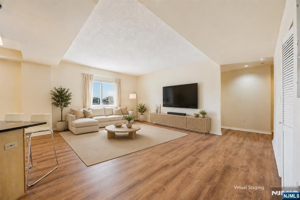 Bright and spacious 2-bedroom, 2-bath condo in a well-maintained building built in 2003. This inviting home features a functional open layout with 9-foot ceilings, hardwood floors throughout, and a modern kitchen with granite countertops and stainless steel appliances. Enjoy the convenience of an in-unit washer and dryer, double-pane windows, and two deeded indoor parking spaces (#6 & #30). Ideally located in the heart of Palisades Park, just minutes from NYC transportation, major highways, shopping, restaurants, cafes, schools, and parks. A wonderful opportunity to own a spacious home in one of Bergen County's most convenient locations.