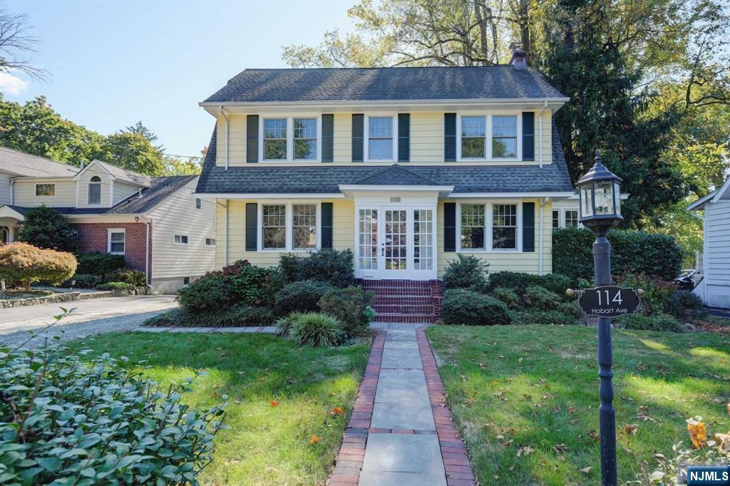 Nestled in the heart of Old Short Hills, this charming 4-bedroom, 1.5-bathroom home is where comfort meets convenience. The first floor welcomes you with soaring 9-foot ceilings and an updated open-concept kitchen featuring a central island-ideal for casual breakfasts. The elegant living room boasts a cozy fireplace, flowing seamlessly into the open dining area and a sun-drenched sunroom with a modern half-bath, creating a perfect space for relaxation and recreation.The second floor hosts 3 generously sized bedrooms, each offering ample space and storage, including two custom-built closets and an updated full bathroom. The fully finished third floor adds a brand-new fourth bedroom, ideal for guests or a private home office. With newer windows throughout, natural light fills every corner of the home, highlighting the beauty of the hardwood floors with the comfort of carpet in the upstairs bedrooms.