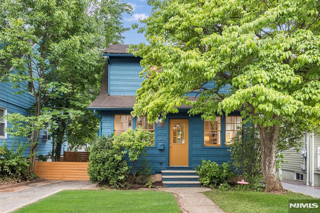 Charming and full of character, this classic Colonial cottage offers the perfect blend of timeless appeal and modern convenience in a sought-after West Orange location. The welcoming enclosed front porch sets the tone for the warm and inviting interior, featuring three bedrooms and a thoughtfully updated kitchen that opens seamlessly to the dining room ideal for everyday living and entertaining. Outside, the property truly shines with exceptional outdoor living spaces. Enjoy gatherings on the raised deck adjacent to the garage and additional entertaining space in the driveway area, creating a unique and versatile outdoor retreat. The oversized two-car garage is a rare find, complete with an unexpected artist's loft above featuring a convenient half bath perfect as a creative studio, workspace, hobby room, or private getaway. Ideally located in the popular Redwood Elementary School district, this home offers easy access to everyday conveniences and commuter options. Nestled between both the Orange and Montclair's Bay Street train stations and just moments from the Mississippi Loop bus stop, commuting is a breeze. Recreation and shopping are equally convenient, with the West Orange town pool, Essex Green mall, Whole Foods, Target, CVS, restaurants, and local amenities all nearby. A wonderful opportunity to enjoy classic Colonial charm, flexible bonus space, and an unbeatable location in the heart of West Orange.