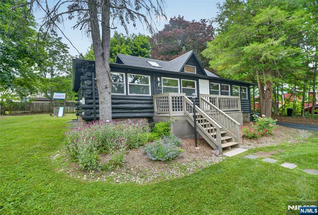 Welcome to 53 Lakeview Drive, a charming log cabin tucked in the sought-after Lindy's Lake community in Lower West Milford! This completely renovated cabin offers 2 bedrooms plus an additional sleeping loft, and fully updated bath. The new kitchen and bath anchor a home that blends fresh finishes with traditional cozy log cabin character. A fireplace sets the scene for warm winter nights, while the huge backyard delivers space for fire-pit gatherings and a hot tub under the stars. Covered parking adds everyday convenience. Enjoy full lake rights and access to the community's sandy beach on Lindy's Lake -- a spring-fed lake known for its crystal-clear water that offers resort-style living, every day. It's perfect for swimming all summer long, and ice skating and ice fishing once the winter sets in. The home is ideally located: close to Warwick skiing and area attractions, with an easy commute of under an hour to Manhattan. Currently operating as a successful Airbnb investment property with incredible returns. This is a rare turnkey opportunity for buyers looking to continue the income stream or make it their own. Live. Invest. Love.