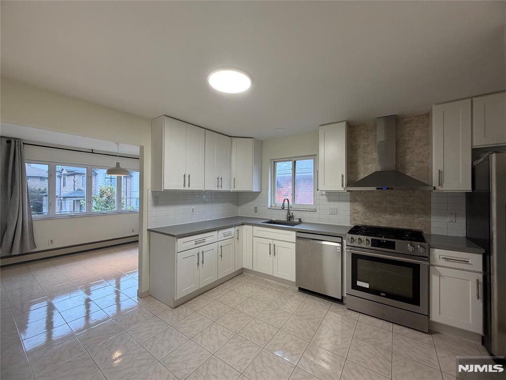 Move-in ready home in a prime location in the heart of Fort Lee. The spacious second floor rear unit of a two-family home (2,028 sqft) features a primary suite with a private bathroom, 2 additional well-sized bedrooms and additional full bathroom, modern kitchen with SS appliances, large living and dining room, on-site laundry. Central a/c, hardwood floor throughout. The ground floor apartment offers a family room, an in-law suite and ideal for a home office, as well as ample storage space. Rent includes a one-car garage (left side), one outdoor parking space (left side), and use of the yard. No pets!