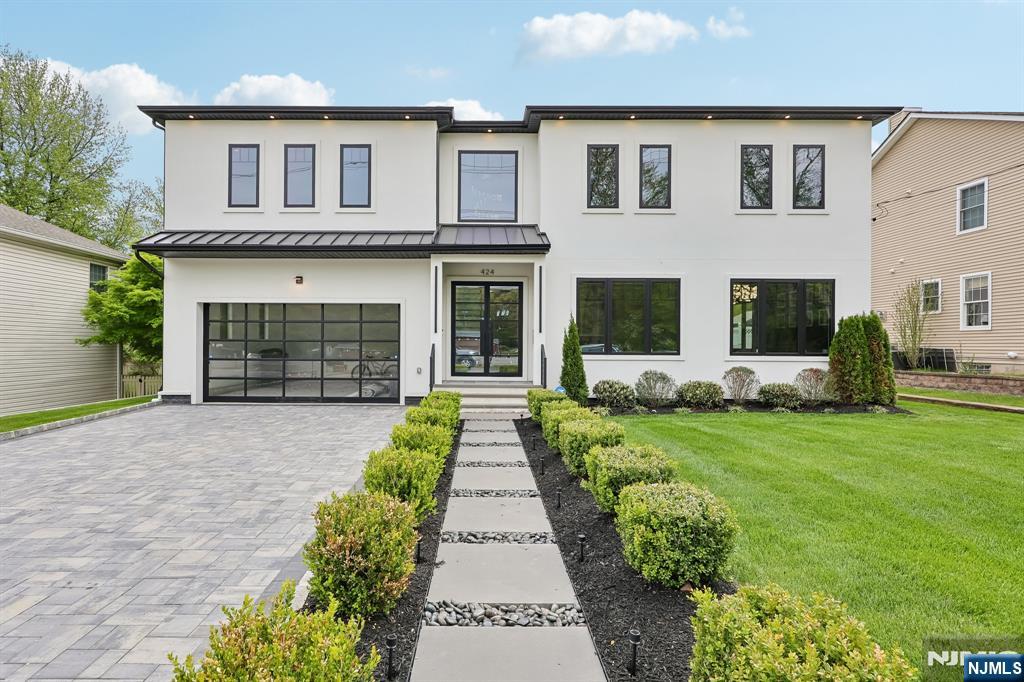 Welcome to a REFINED level of living in Paramus! This new luxury residence offers a seamless blend of elegance and functionality designed for those who value style, space and elevated living.From sunlit interiors-to refined architectural details every inch of this home is crafted to impress! Soaring 2- story ceiling height creates a dramatic sense of space and light. Custom built in 2024, the first floor is surrounded by floor to ceiling windows, the Custom Gourmet Kitchen with magnificent island offers top of the line Thermador s/s appliances. Executive office with glass doors and warm wood panels allows for the perfect private work space. Every bedroom is thoughtfully designed as a private en suite offering ultimate comfort and privacy. Primary en suite w/FP,WIC and sauna! Finished basement is an entertainer's dream, w/dedicated movie theater, billiard room and lounge w/FP perfect for hosting unforgettable gatherings or enjoying a true cinematic experience at home. BR ensuite with egress window also on lower level for those guests that just don't want to leave! Stately manicured fenced in property with BRAND NEW deck with extended covered area and patio with seating and fire-pit for cozy summer or winter evenings! Thoughtfully landscaped with premier outdoor lighting illuminating the yard without overwhelming.Underground sprinklers. Close to schools,NJ Transit buses and park and ride to NYC, Rt 17, Rt4 and all the shopping and restaurants this wonderful town has to offer.