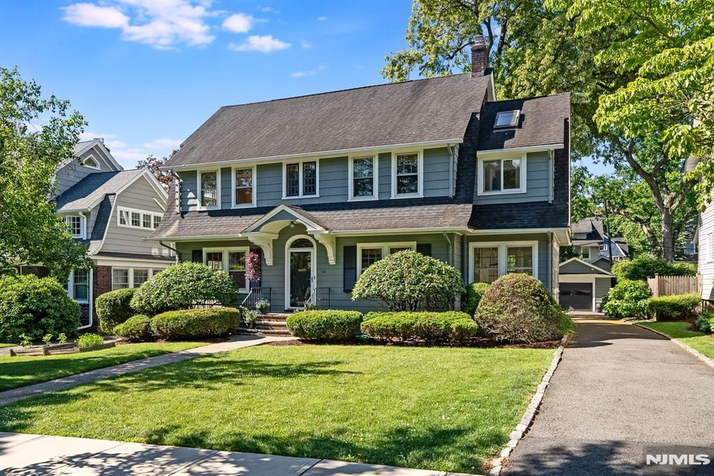 This pretty Dutch Col on a beloved tree-lined street in Up Mtc's popular Watchung Plz neighborhood is a perfect blend of urban energy & suburban charm. This exceptional home is moments from restaurants, boutiques, NY train & bus & 121-acre Brookdale Pk & has the welcoming curb appeal of a classic Montclair home. Inside, modern updates complement its period character w/leaded eyebrow wdw, hw flrs, molding & brick fp. A spacious LR w/built-ins leads to a beautiful sunroom perfect as a dreamy WFH space. The DR opens to the kitchen, for casual & formal dining. The renovated kit has Plain & Fancy cherry Shaker cabinetry, pullout pantry, ss appl incl a 6-burner range, leathered granite counters & peninsula island. New wdws & glass doors provide views & access to the deck & yard. 3 lg 2nd flr BRs & updated BA offer comfortable space upstairs. The primary suite incl a large BR, a versatile dressing room/office & updated BA w/quartz counter & walk-in shower. The 3rd flr offers a beautiful flex space w/brick, skylights, built-ins & closets. Along w/an add'l BR & full BA, this could be a private primary suite. CAC on the 2nd & 3rd flrs. The bsmt offers potential as rec space or future finished living space, equipped w/French drains & a sump pump. Laundry rm, powder rm & storage complete this level. With lush landscaping, the yard is a private oasis for dining al fresco on the deck, gardening, or relaxing with friends. If a house can have a sunny disposition, 54 Aubrey Road has it!