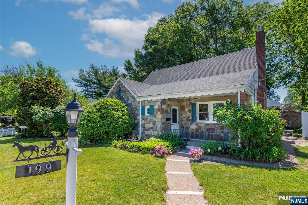 Welcome to this freshly painted expanded Colonial Cape featuring four bedrooms, two full baths, and a sought-after in-town location near Villano Elementary School, local shops, and approximately one-quarter mile from Emerson Train Station with service to New York City. The main level features a welcoming living room with a fireplace and insert, a spacious kitchen with a breakfast bar that opens to the dining area, and a cozy step-down family room with slate flooring. Newer stainless steel appliances enhance the kitchen's appeal. Two bedrooms, including the primary, are conveniently located on the first floor and feature hardwood floors. An updated full bath offers ceramic tile, a granite-topped vanity, and a classic claw-foot soaking tub. Upstairs are two additional bedrooms with parquet flooring. The finished lower level provides exceptional living and entertaining space with a large bar area, lounge area, full bath, laundry area, workshop, and ample storage. Outside, enjoy a fenced yard, patio, and storage shed. Recent improvements include a new roof (2024), sprinkler system (2025), and newer boiler and hot water heater (2017). Additional highlights include central air conditioning. Move-in ready, this home offers comfort, convenience, and plenty of space to enjoy.