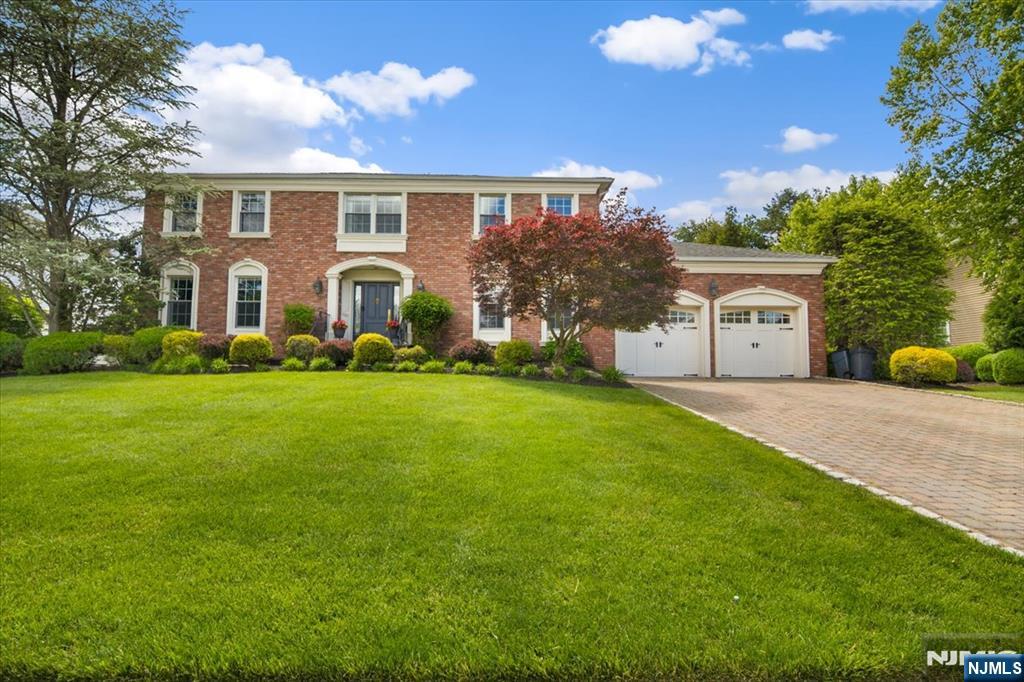 Welcome to 12 Longell Drive, where exceptional craftsmanship & timeless elegance create a home designed for the most discerning buyer. At the heart of the home is a stunning chef's kitchen featuring a 60" Wolf range w double ovens, Sub-Zero refrigerator, beverage center, dedicated coffee station & an impressive 5x9 center island w vegetable sink. Designed for both everyday living & entertaining, the kitchen opens seamlessly to a warm family room w fireplace, creating the perfect gathering space. The thoughtfully designed main level also offers a formal dining room, elegant living room w fireplace, private study w French doors, expansive mudroom off the garage, laundry room & powder room. Rich Brazilian hardwood flooring, exquisite millwork, custom paneling & detailed wainscoting elevate every space. Basket-weave tile, uniquely incorporated into each bathroom, creates a cohesive design throughout the home. The luxurious primary suite features a custom walk-in closet w built-ins & a spa-inspired bath complete w a rain shower head & body jets. The fully finished lower level provides dedicated spaces for fitness, movie nights & recreation, with plumbing already in place for a future bathroom. Outside, enjoy your own private retreat w a multi-level paver patio, outdoor built-in kitchen, multiple seating areas & a stunning waterfall feature. Every detail has been carefully curated to deliver luxury, comfort, & functionality, making this a truly exceptional place to call home.
